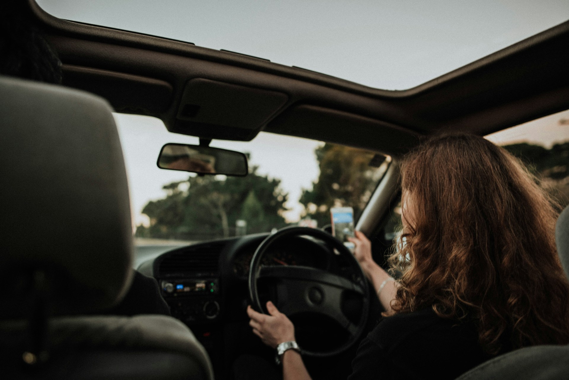 a person driving while distracted by texting